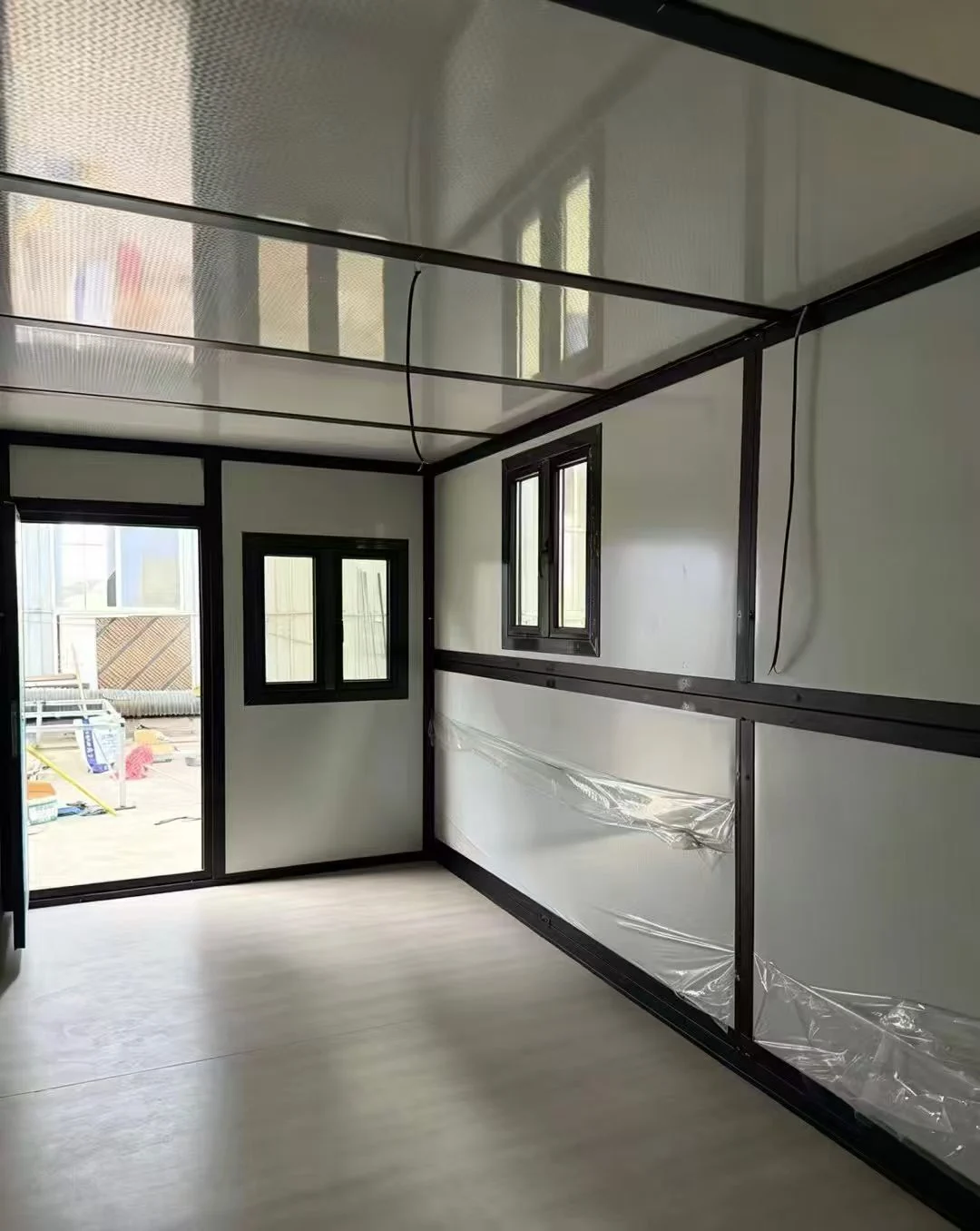 Folding container house interior shell with kitchen wall