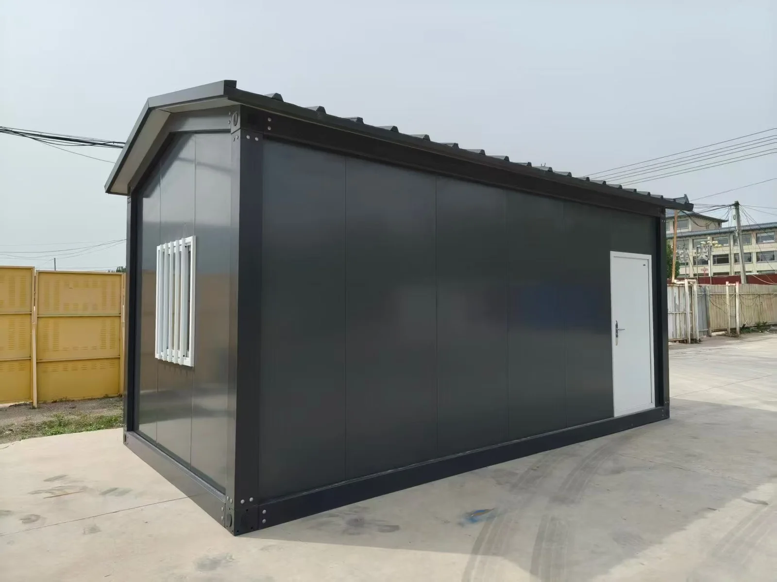 Black modular unit with pitched roof